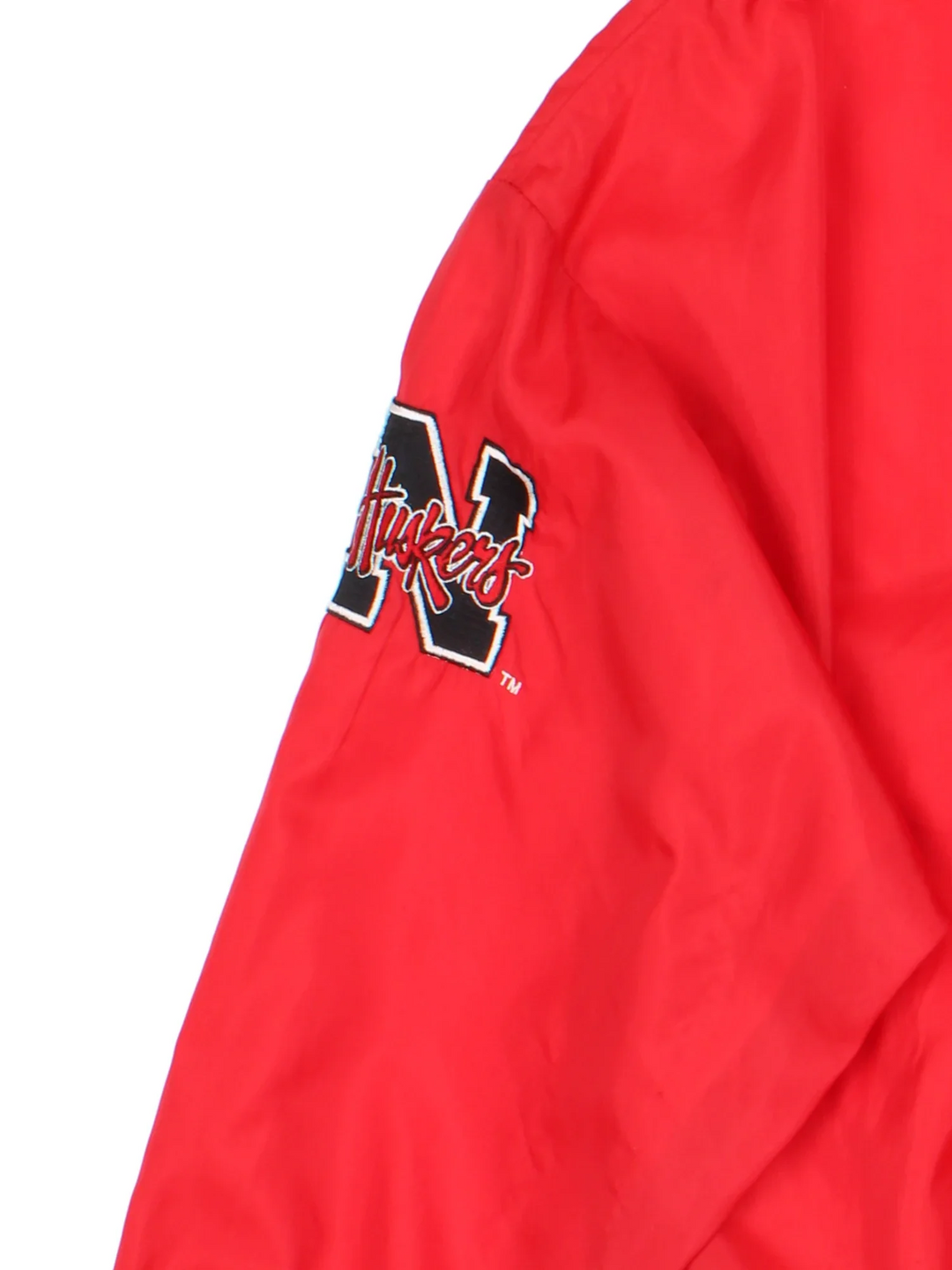 Starter Nebraska Drill Top in the red colourway. Features contrast cuffs/hems, side pockets and logos embroidered on the front/back/sleeve.