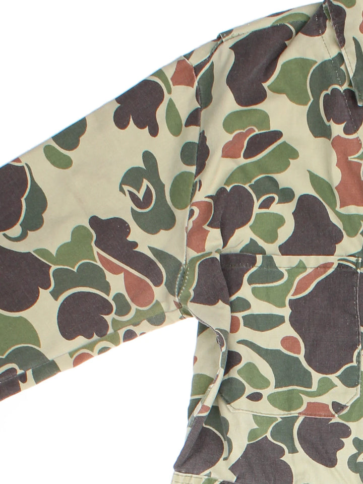 Vintage Walls Camo Overalls in a green and brown colourway with multiple pockets and button up collar.