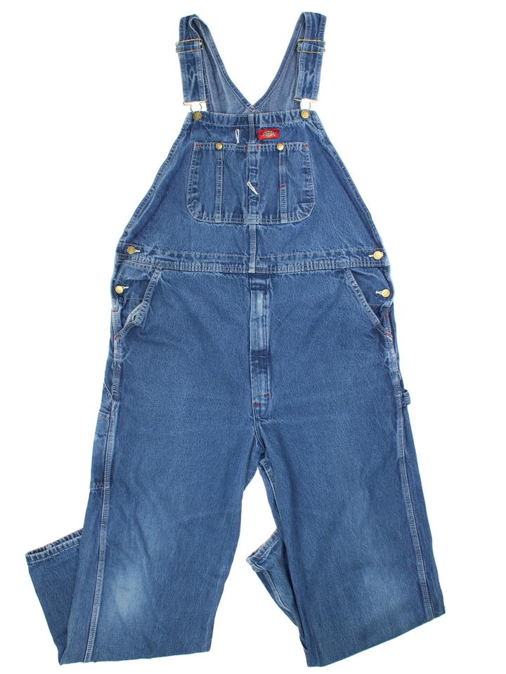 Dickies Denim Dungarees in a blue colourway with multiple pockets and the logo embroidered on the front.