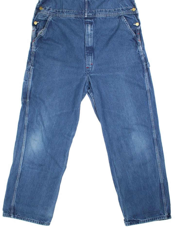 Dickies Denim Dungarees in a blue colourway with multiple pockets and the logo embroidered on the front.