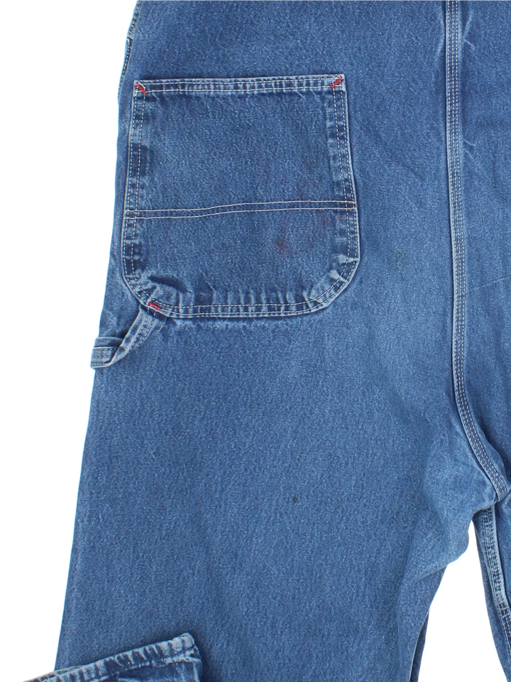 Dickies Denim Dungarees in a blue colourway with multiple pockets and the logo embroidered on the front.