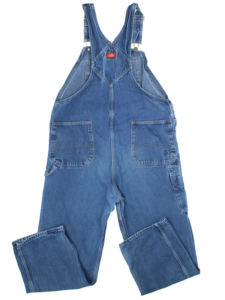 Dickies Denim Dungarees in a blue colourway with multiple pockets and the logo embroidered on the front.
