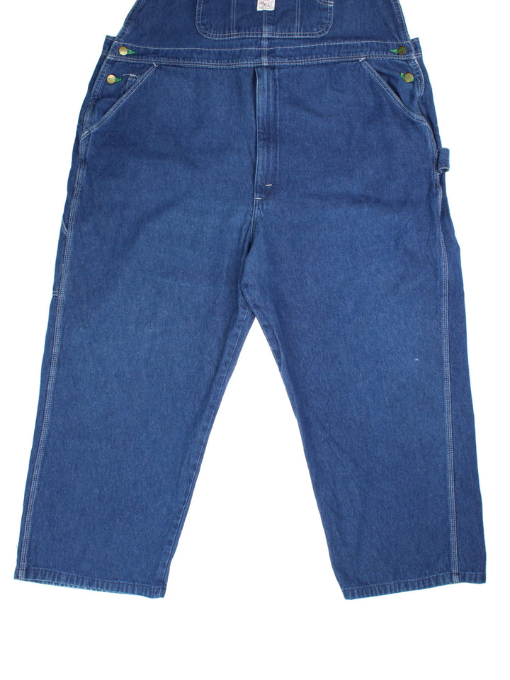 Vintage Pointer Dungarees in blue colourway with multiple pockets, adjustable straps, and the logo embroidered on the front.