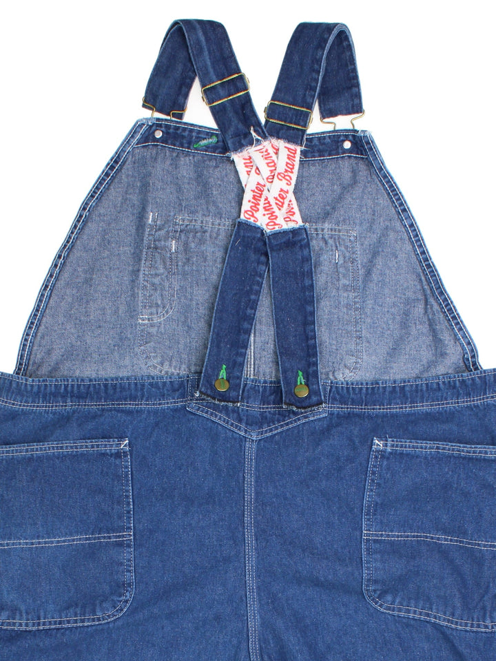 Vintage Pointer Dungarees in blue colourway with multiple pockets, adjustable straps, and the logo embroidered on the front.