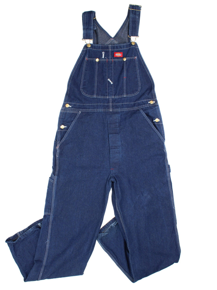 Dickies Dungarees in blue colourway with multiple pockets, adjustable straps, and has the logo embroidered on the front.