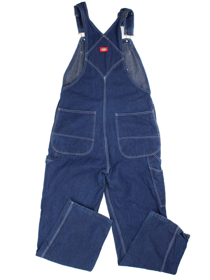 Dickies Dungarees in blue colourway with multiple pockets, adjustable straps, and has the logo embroidered on the front.