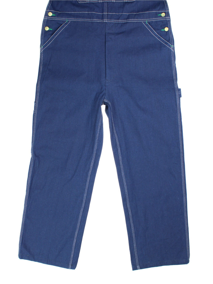 Vintage Liberty Dungarees in blue colourway with multiple pockets, adjustable straps, and the logo embroidered on the front.
