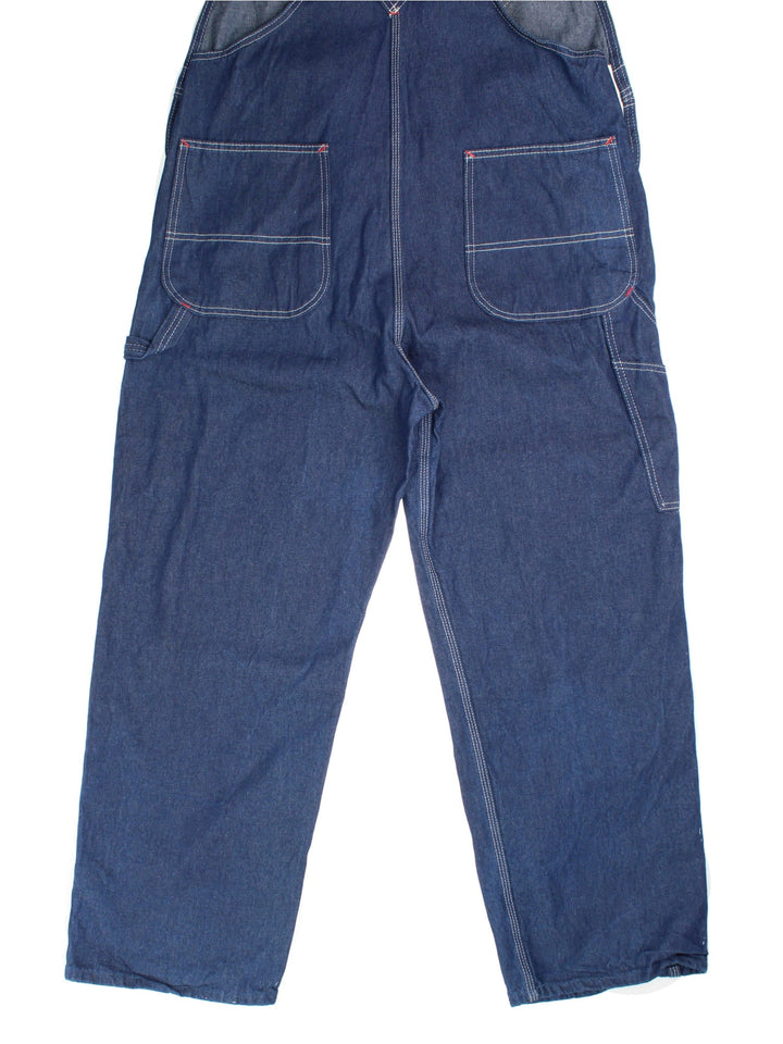 Dickies Dungarees in blue colourway with multiple pockets, adjustable straps, and the logo embroidered on the front.