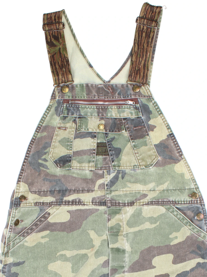 Vintage Liberty Camo Dungarees in green colourway with multiple pockets, branded buttons and the logo embroidered on the front/back.