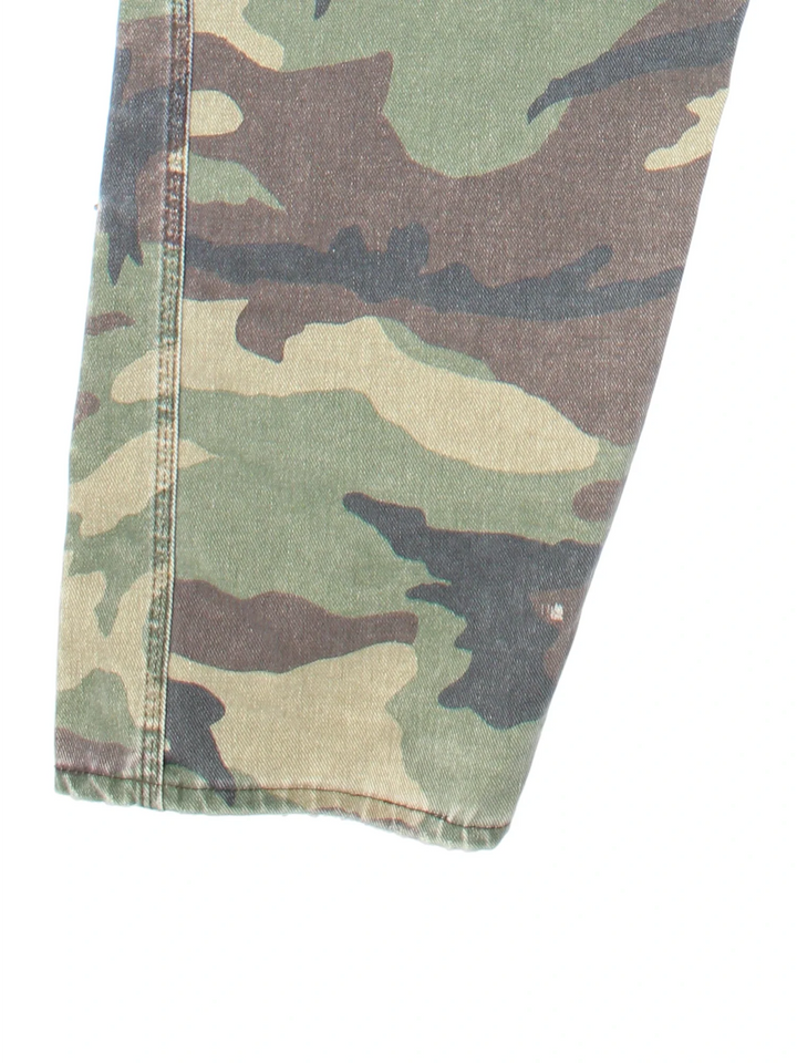 Vintage Liberty Camo Dungarees in green colourway with multiple pockets, branded buttons and the logo embroidered on the front/back.