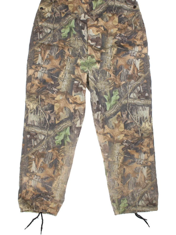 Vintage Liberty Camo Dungarees in green colourway with multiple pockets, branded buttons and the logo embroidered on the front/back.