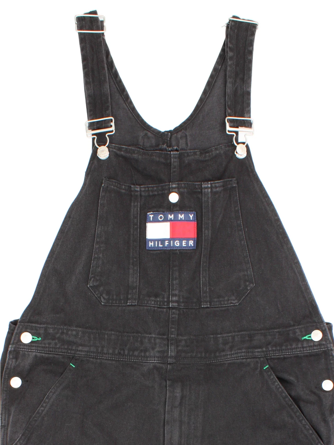 Tommy Hilfiger Dungarees in black colourway with multiple pockets, branded buttons and the logo embroidered on the front/back.