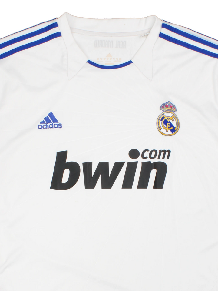 Real Madrid 2010/11  Football Shirt in the  home kit colourway, features embroidered logos and badge on the front.