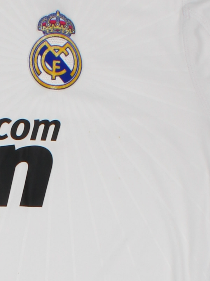 Real Madrid 2010/11  Football Shirt in the  home kit colourway, features embroidered logos and badge on the front.
