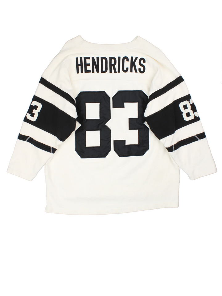 Hendricks NFL American Style Jersey in a tan colourway, features large number on the front with black stripe detailing on the sleeves and player name Hendricks #83 on the back.