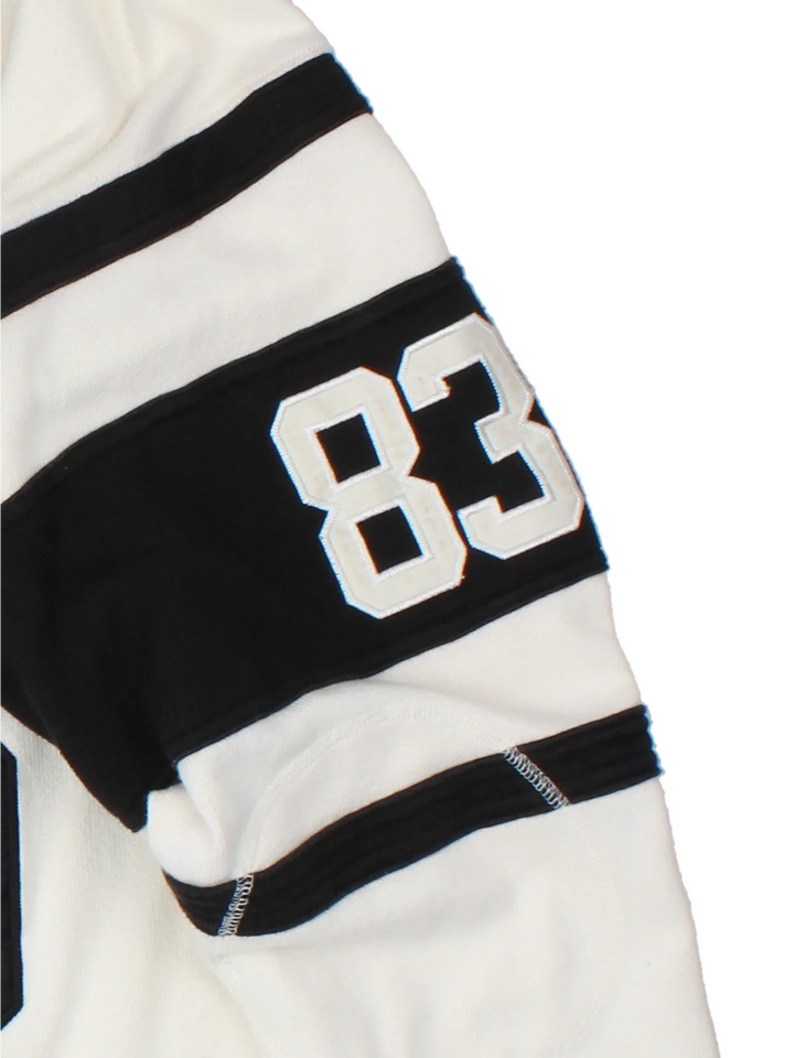 Hendricks NFL American Style Jersey in a tan colourway, features large number on the front with black stripe detailing on the sleeves and player name Hendricks #83 on the back.