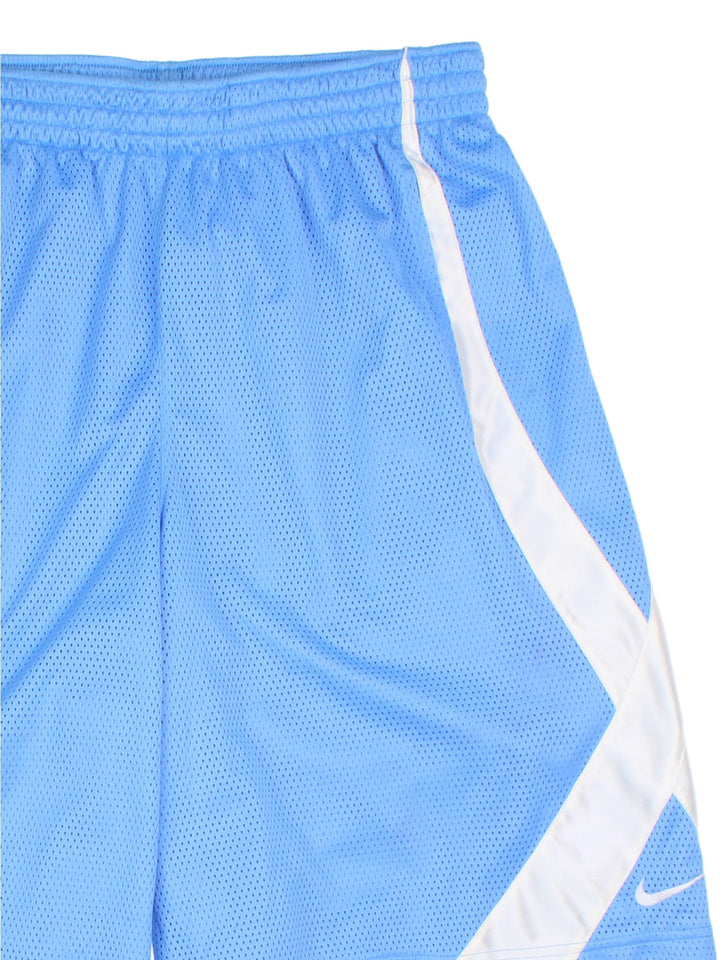 Nike Dri-Fit Basketball Shorts in a blue and white colourway, has and adjustable waist, side pockets and the swoosh logo embroidered on the front. 