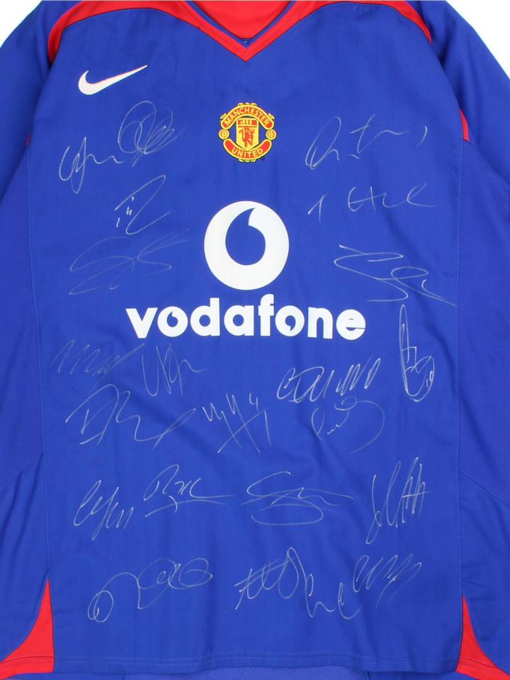 Manchester United 2005/06, Nike Football Kit in a blue, white and red colourway, signed by the players, V-neck and has logos printed on the front.