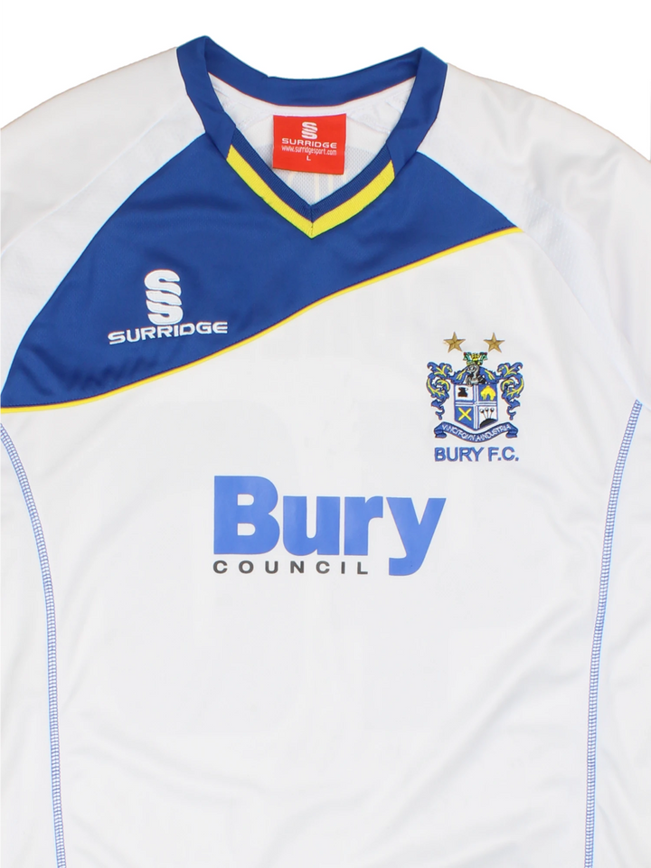 Vintage Bury FC 2012/13 Football Shirt in the white and blue home kit colourway, features embroidered logo and badge on the front, and on the back has Morley number 40 printed alongside team signatures.