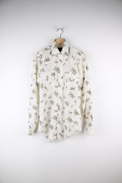 Vintage 70's/80's Champion Westerns western shirt in light tan, features all over floral print, pearl snap buttons and yoke on the front and back 