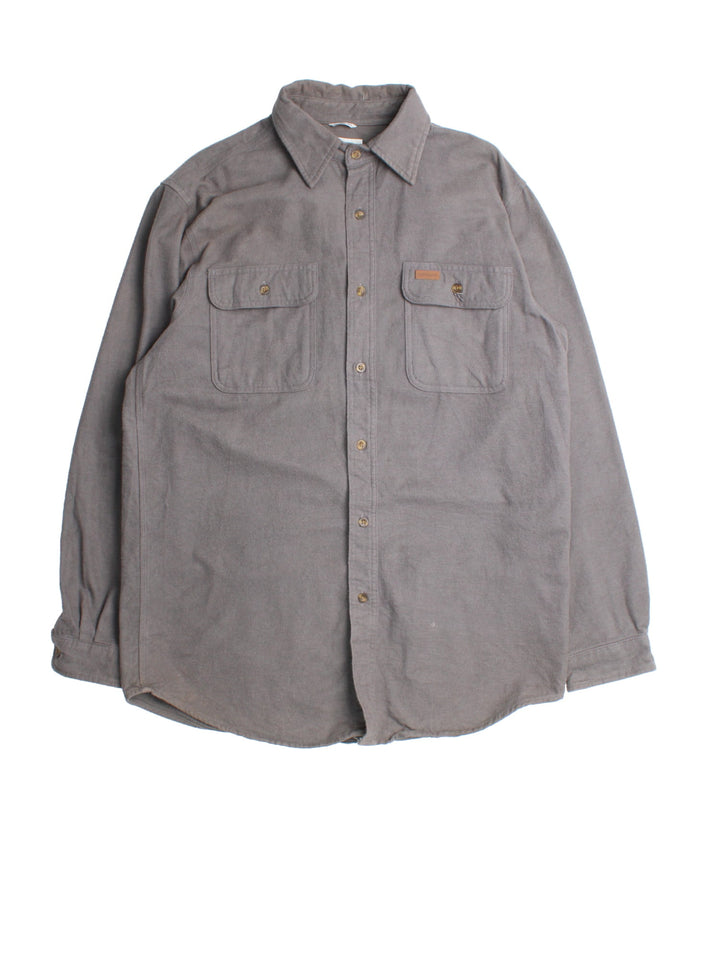 Carhartt Shirt in a grey colourway, button up with front patch pockets and leather branding tab.