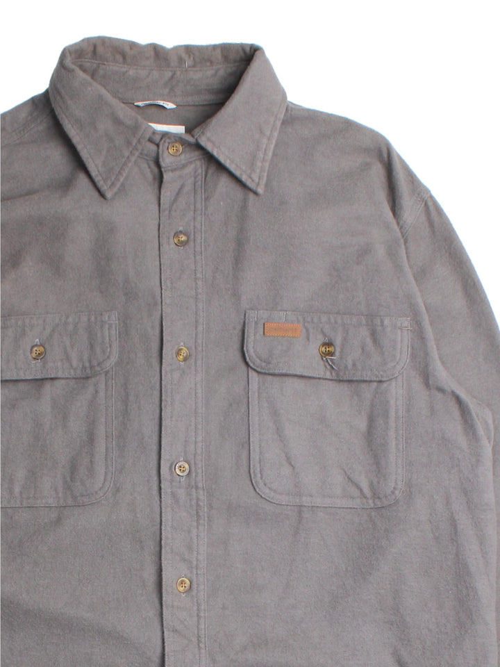 Carhartt Shirt in a grey colourway, button up with front patch pockets and leather branding tab.
