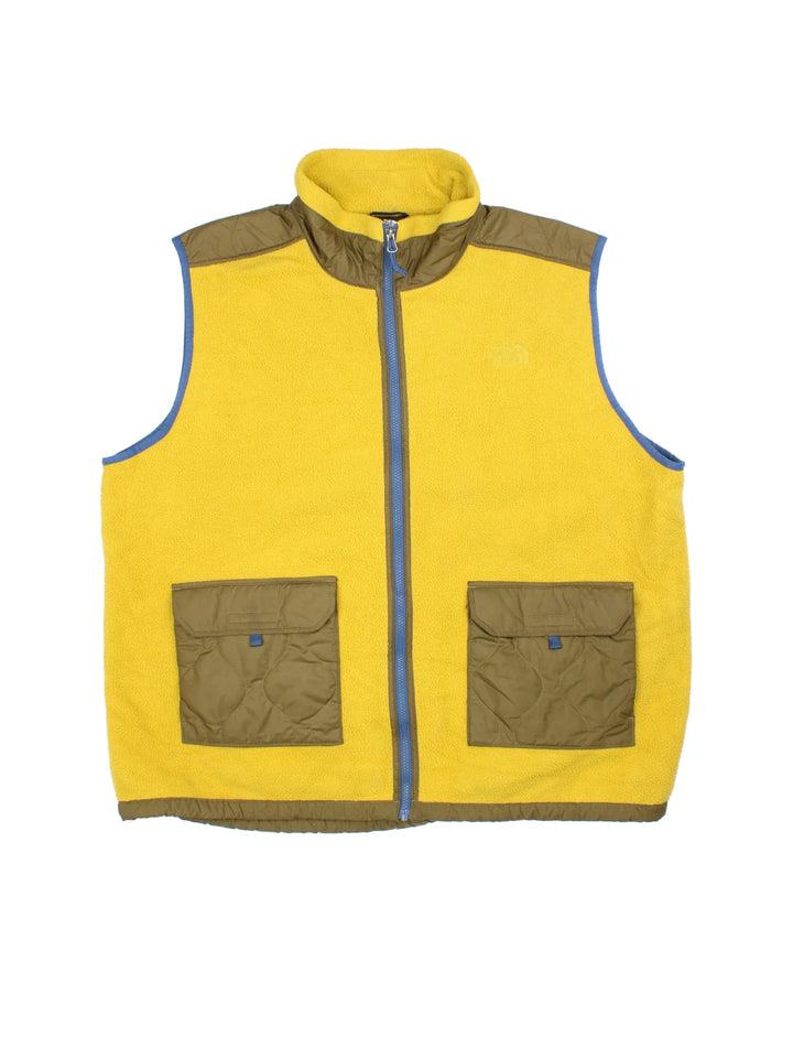 The North Face Royal Arch Fleece Vest in a yellow/green colourway. Zip up fastening, with contrast patch pockets and back panel. Logo embroidered on the front.