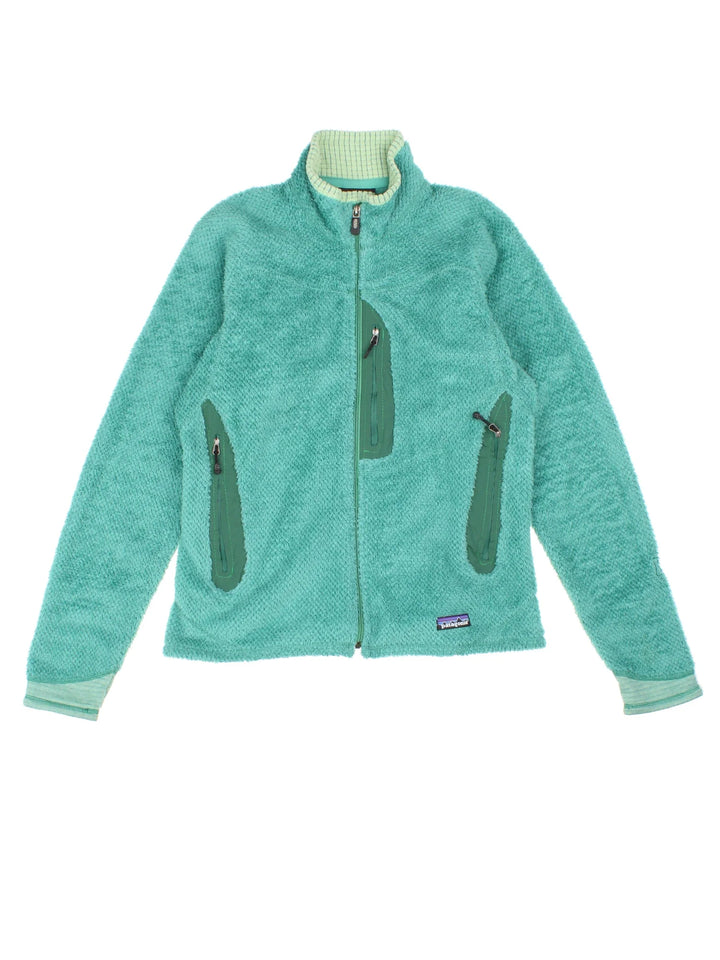 Patagonia R2 Fleece in a turquoise blue colourway. Zips up and has multiple pockets, and the logo embroidered on the front.
