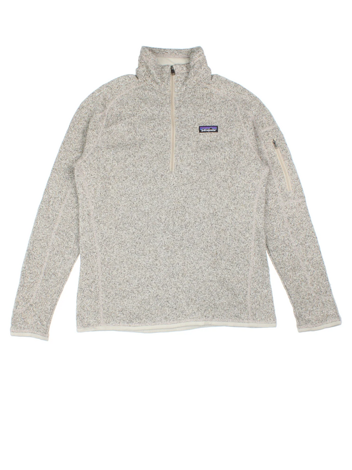 Patagonia Fleece in a tan / grey colourway. Half zip up closure and has a pocket on the left sleeve, and the logo embroidered on the front.