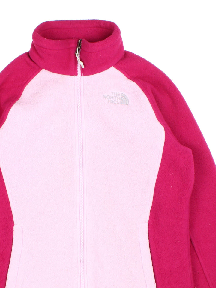 The North Face Fleece in a pink colourway with dark pink sleeves and collar. Full zip with multiple pockets and classic small logo on the front.
