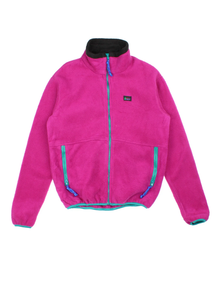 Vintage 90's REI Fleece in a pink colourway. Zips up and has side pockets, and the logo embroidered on the front.