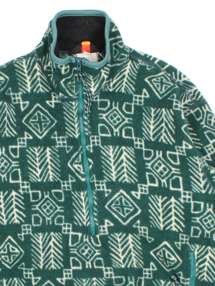 Vintage 90's REI Patterned Fleece in a green colourway with all over abstract pattern. Half zip closure and has a pouch pocket, and the logo embroidered on the back of the collar.