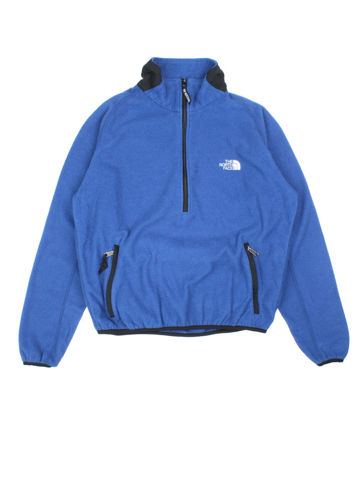 Vintage The North Face Pullover Fleece in a blue colourway. Half zip closure and has side pockets, and the logo embroidered on the front and back.