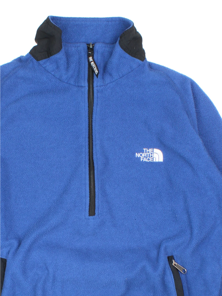 Vintage The North Face Pullover Fleece in a blue colourway. Half zip closure and has side pockets, and the logo embroidered on the front and back.