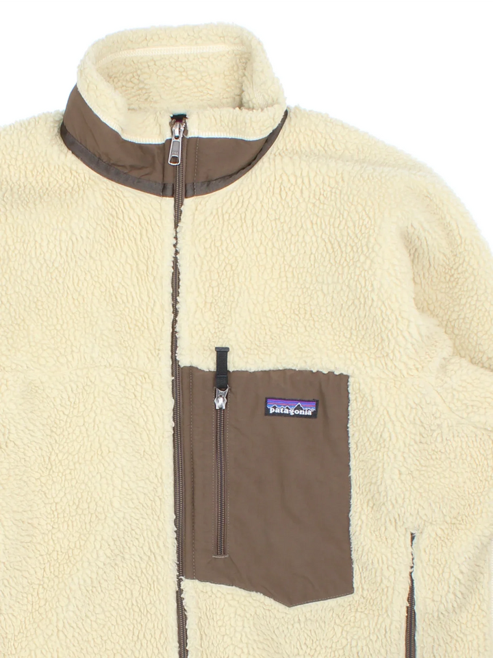 Vintage Patagonia Retro-X Fleece in a tan colourway. Zips up and has multiple pockets, and the logo embroidered on the front.