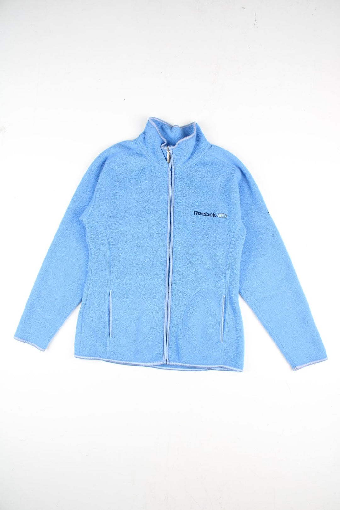 Vintage Reebok Fleece in a blue colourway. Zip up fastening with side pockets, branding embroidered on front and back.