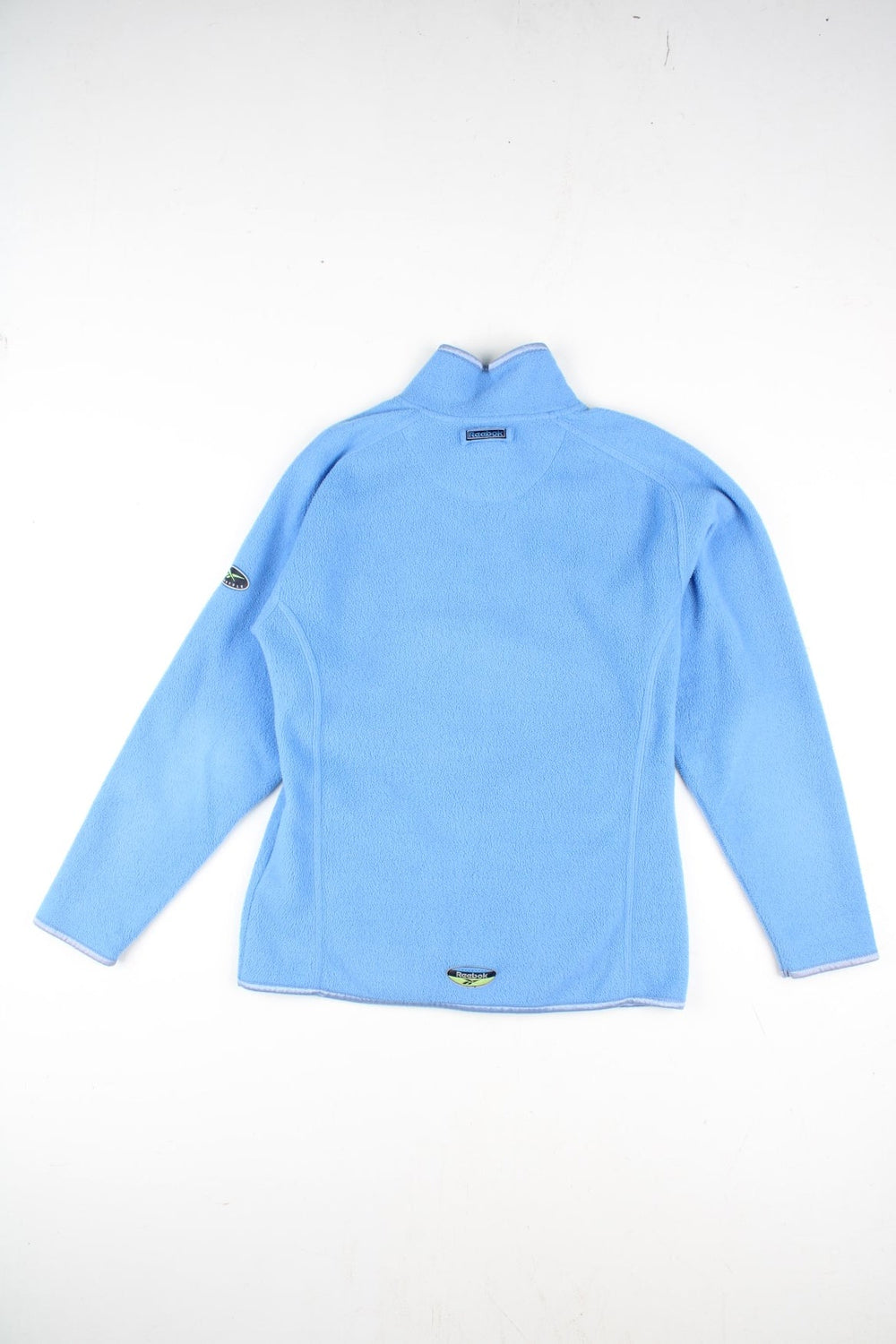 Vintage Reebok Fleece in a blue colourway. Zip up fastening with side pockets, branding embroidered on front and back.