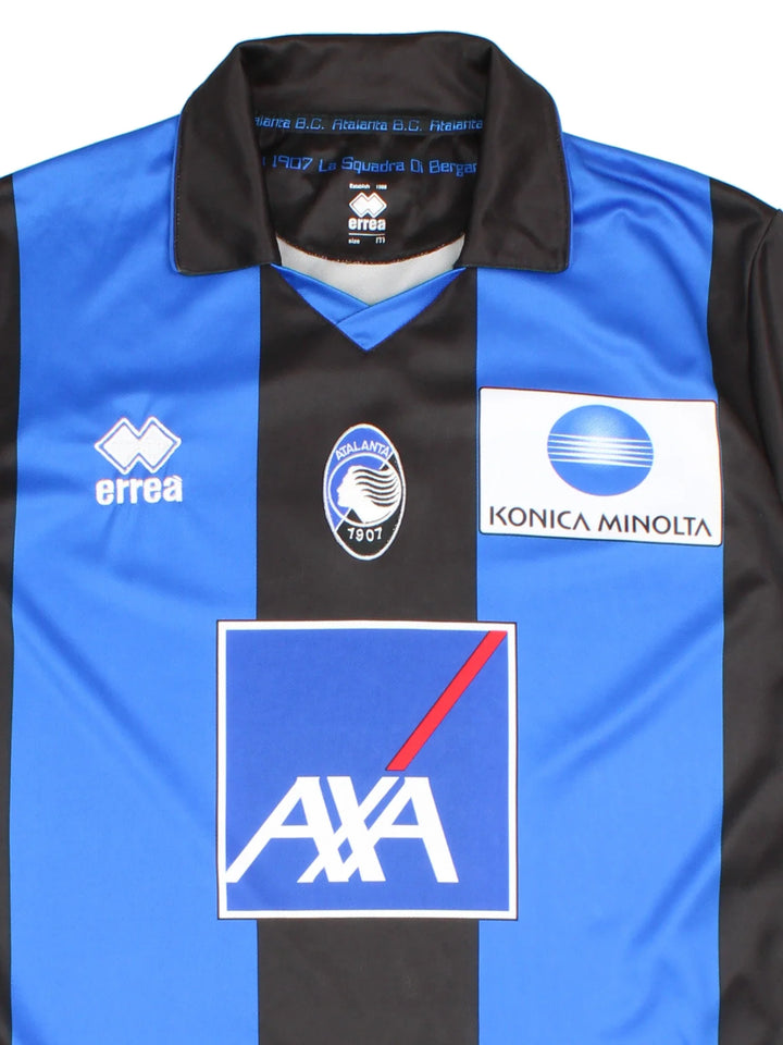 2012/13 Atalanta Vintage Football Shirt in a blue  and black stripe colourway, features embroidered logos and badge on the front, collar and large sponsor on the front also.