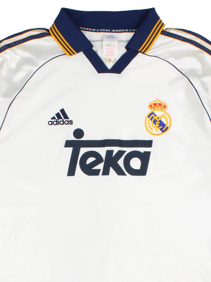 1998/00 Real Madrid Adidas Football Shirt in a white colourway with the classic adidas 3 stripe along the sleeve and gold detailing. Logo and badge on the front with vintage sponsor.