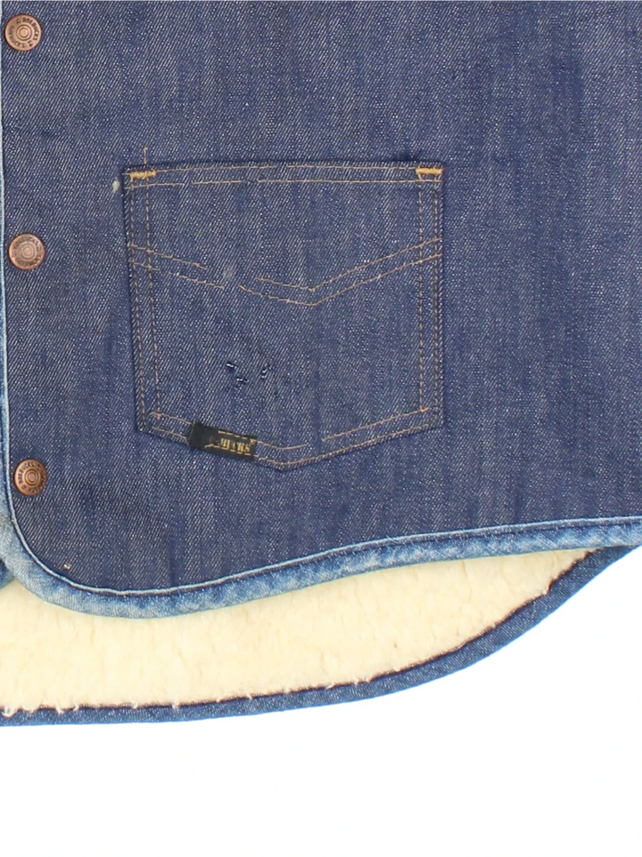 Vintage Roebuck Denim Shearling Vest in a blue colourway. Buttons up, with front patch pockets and branding embroidered on front.