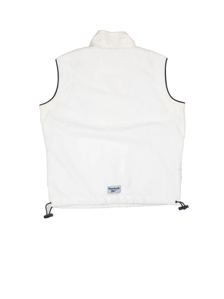 Reebok Athletic Department Pullover Vest in a white colourway. Half zip closure with a pouch pocket, and has the logo embroidered on the front and back.