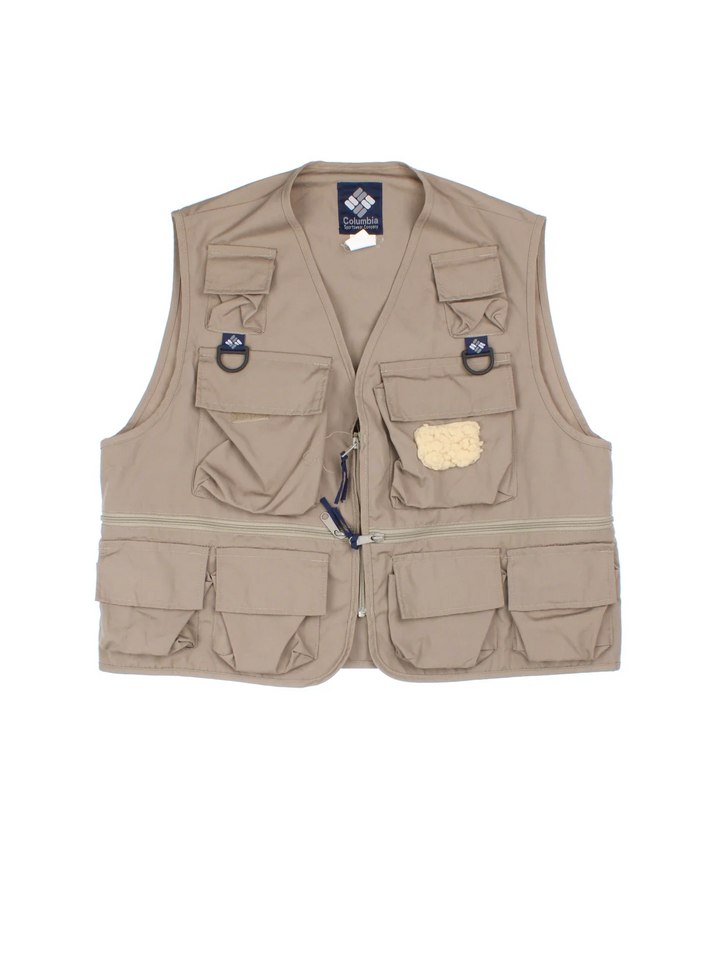 Vintage Columbia Fishing Vest in a tan colourway. Half zip up closure with multiple utility pockets, and has the logo embroidered on the front.