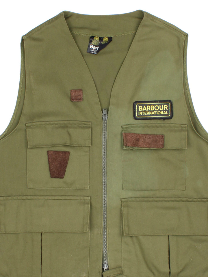 Vintage Barbour Fishing Utility Vest in a green colourway. Zips up and has multiple pockets, and the logo embroidered on the front.