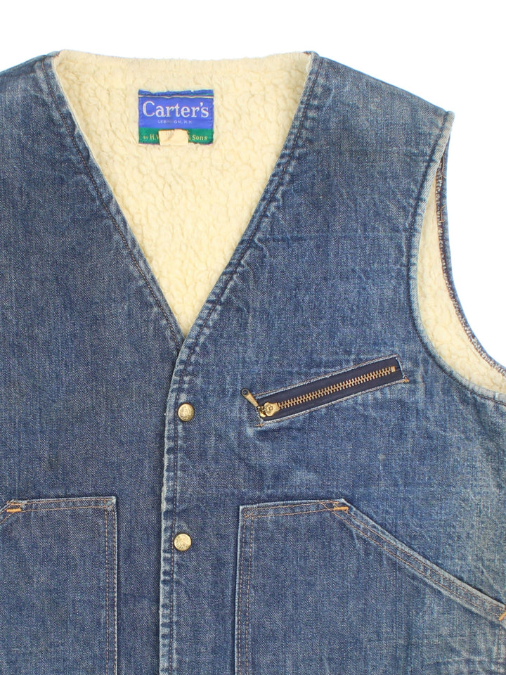 Vintage Carter's Denim Vest in a blue colourway. Buttons up and has multiple pockets, and is insulated with a sherpa lining.