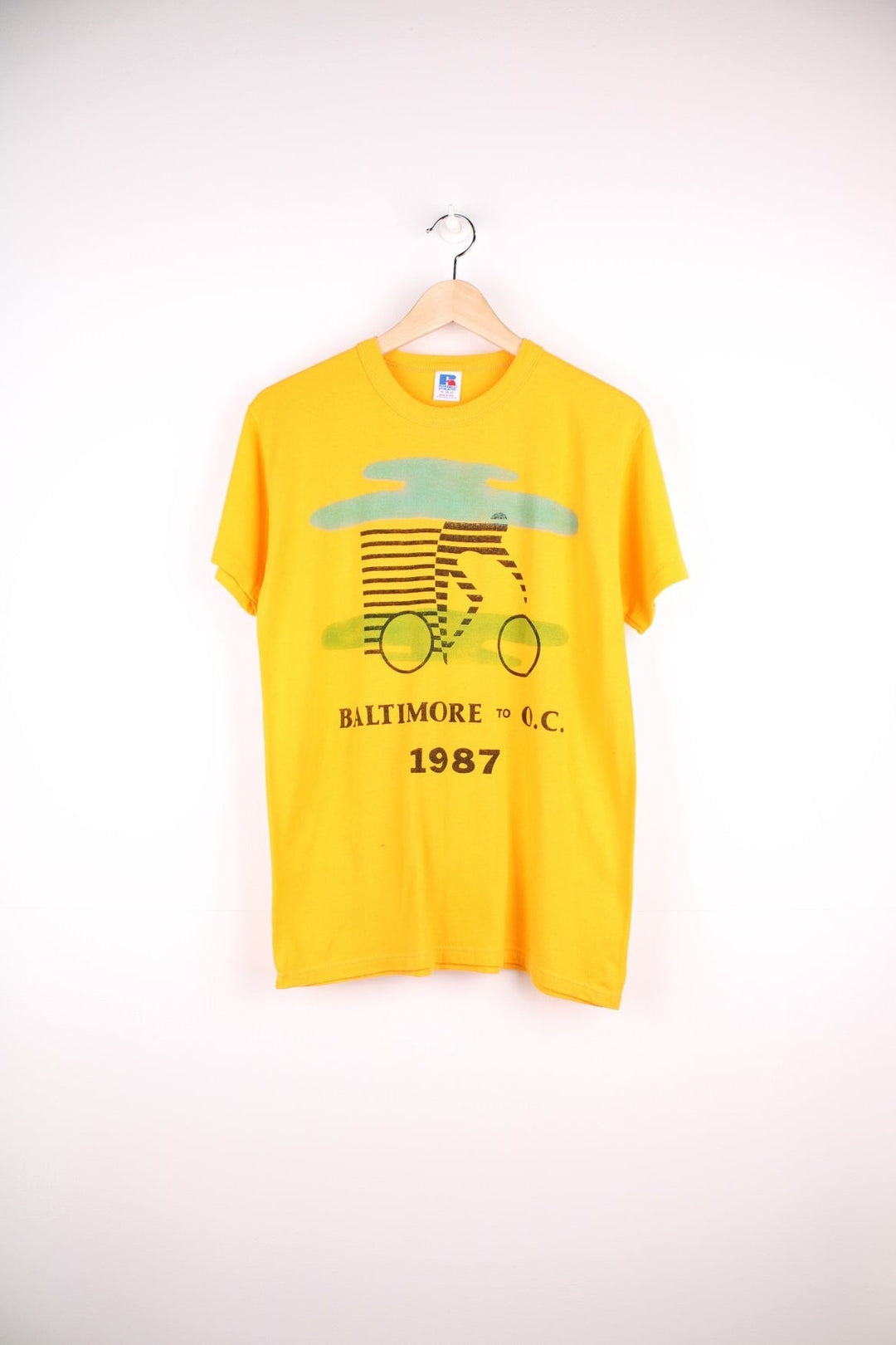 Vintage 1987 Baltimore to O.C. Cyclist T-Shirt in a yellow colourway with the spell out logo and cyclist graphic printed on the front. 