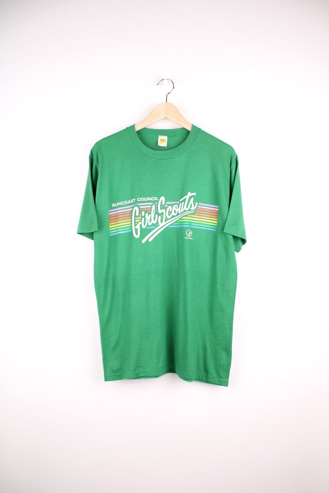 Vintage Suncoast Council Girl Scouts T-Shirt in a green colourway with the spell out logo printed across the front with rainbow coloured stripes going through it. 