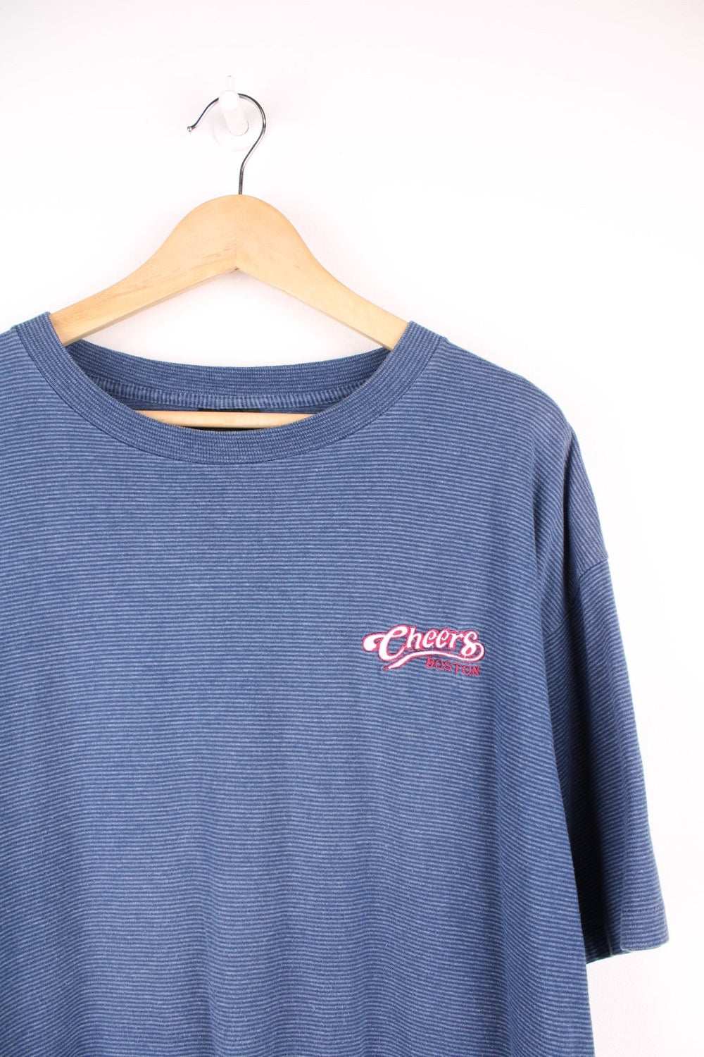 Navy blue horizontal striped tee with 'Cheers Boston' spellout embroidered on the top left. 
