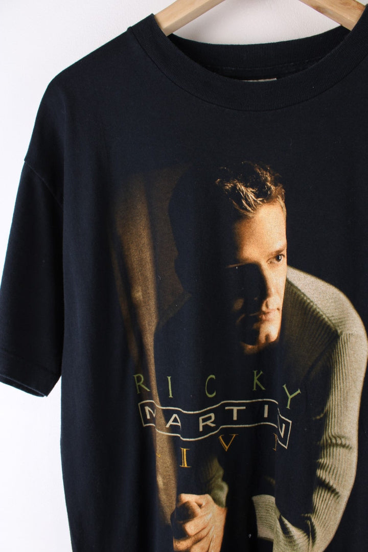 Vintage 2000 Ricky Martin Livin La Vida Loca Tour T-Shirt in a black colourway with Ricky Martin graphic printed on the front and on the back the tour locations.