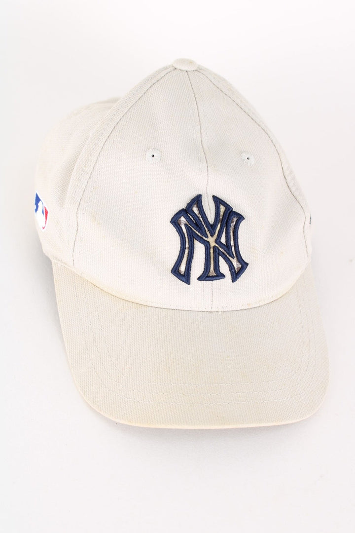 Vintage Adidas New York Yankes Cap in a tan colourway with the logo embroidered on the front and sides, tartan under brim pattern and has adjustable velcro strap.