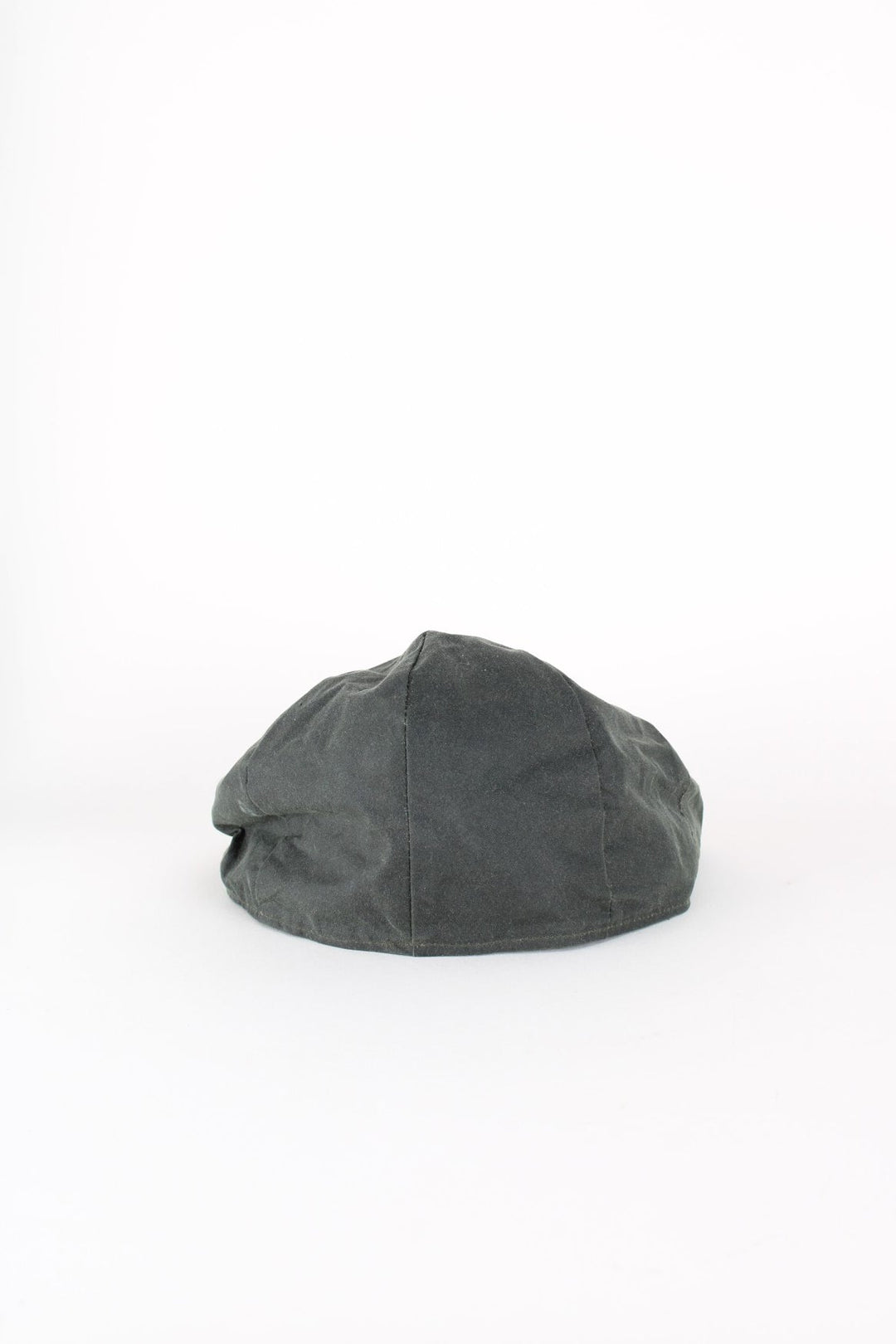 Vintage Barbour Wax Flat Cap in a dark green colourway with tartan lining, and has button closure at the top.